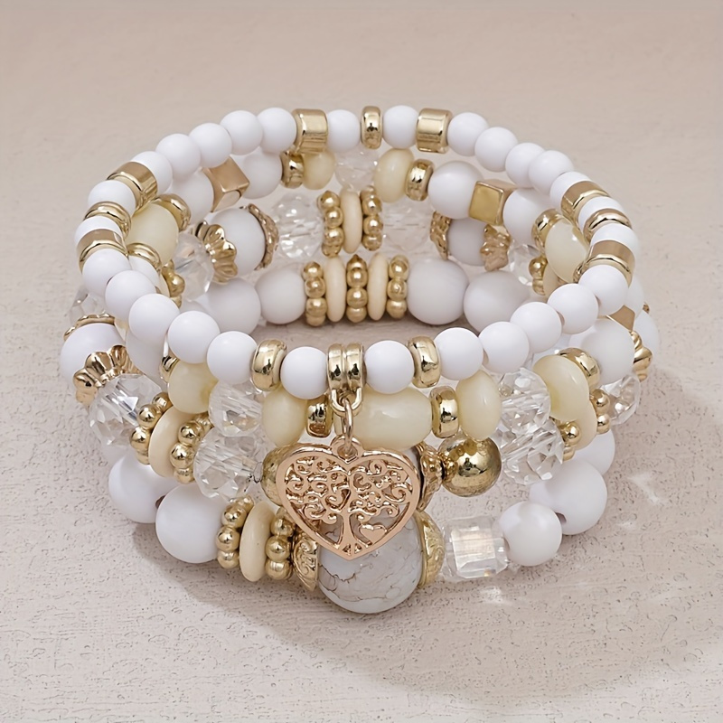 

Bohemian Style Four-piece Handmade Beaded Bracelet Set With Multi-colored Beads, Gold-tone Charms, And A Heart Pendant - And Parties