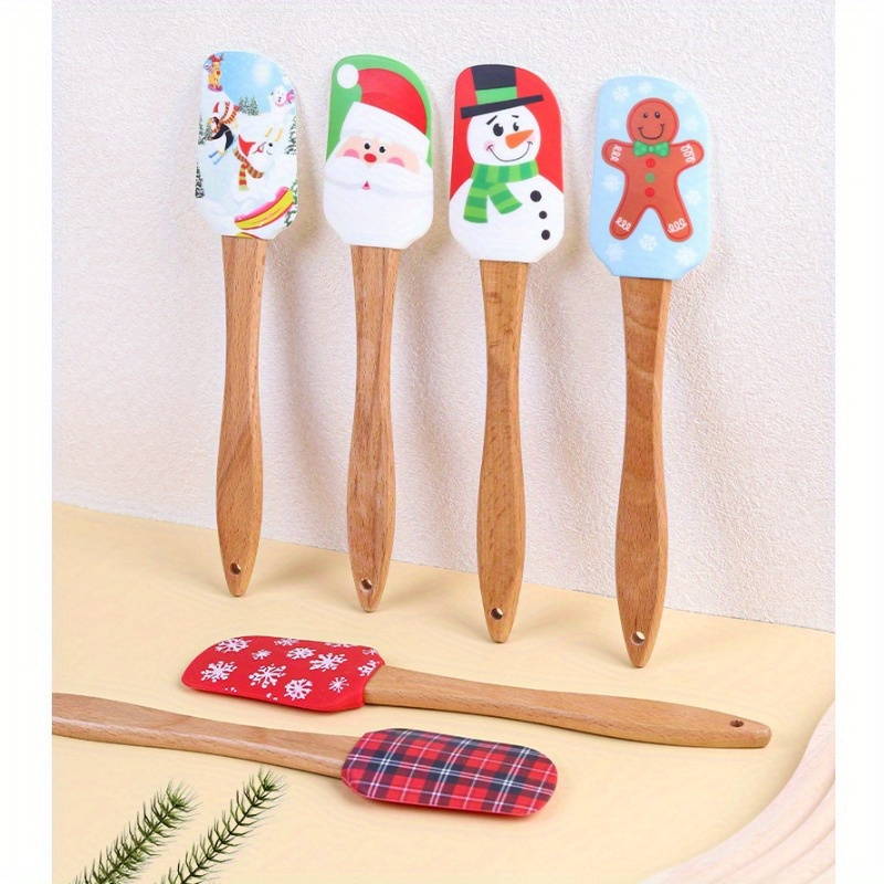 

A Silicone Spatula For Christmas Featuring A Wooden Handle, Ideal For Baking, Cooking, And Decorating Cakes.