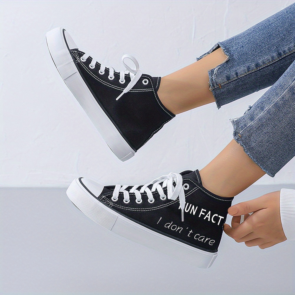 Black and white women's sneakers sold by 100 Spartans