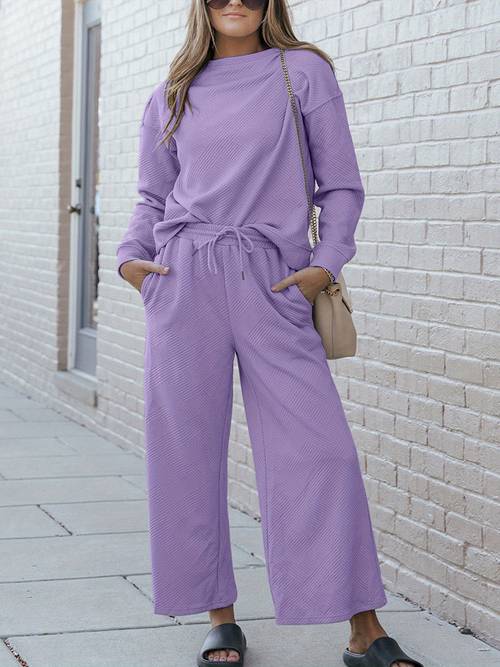 womens two piece set casual lounge set relaxed fit two piece outfit black soft knit fabric long sleeves pullover style relaxed neckline hip length top wide leg pants with pockets drawstring waist solid color comfortable and cozy