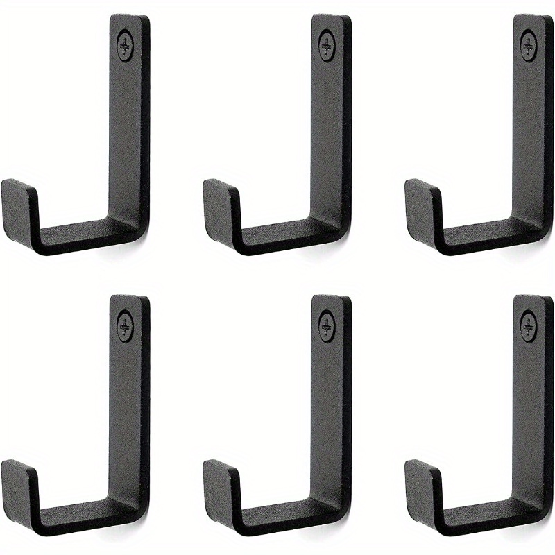 A Black Stainless Steel Hook For Clothes Is Mounted On The Bathroom Wall, With Hooks For Hats And Clothes Behind The Door And On The Wall.