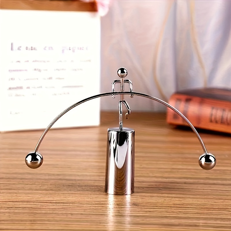 Image of 1pc Balancing Sculpture, Desktop Office Ornament, Dynamic Lifting Figurine Decor, Unique Collectible Gadget Gift, Versatile Indoor/outdoor Metal Pendulum Art Ornament