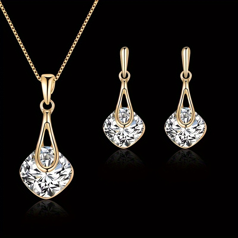 

A Set Of Pieces Of Jewelry Made With 18k Golden Plating, Featuring Square Artificial Crystals, Which Includes A Pendant Necklace And Earrings, Women Attending A Prom.