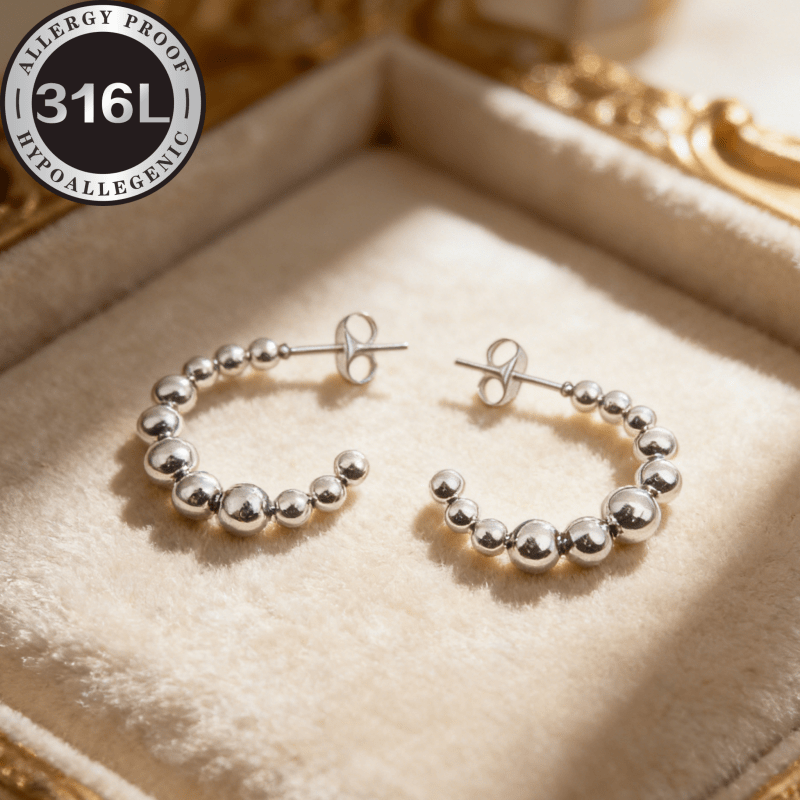 E-shop Hochwertige hypoallergene goldene Ohrringe aus Edelstahl. Kreisförmiges Design mit Stahlperlen, C-förmige Creolen. Lichtbeständig, bequem
