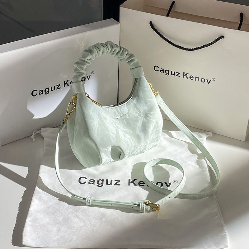 A Single Unit of The Latest Cloud Bag - a Small Pleated Clutch with an Adjustable Shoulder Strap, Featuring a Premium Matte End, Perfect for Everyday Use And Casual Events. This Compact Handbag Exudes Sophistication