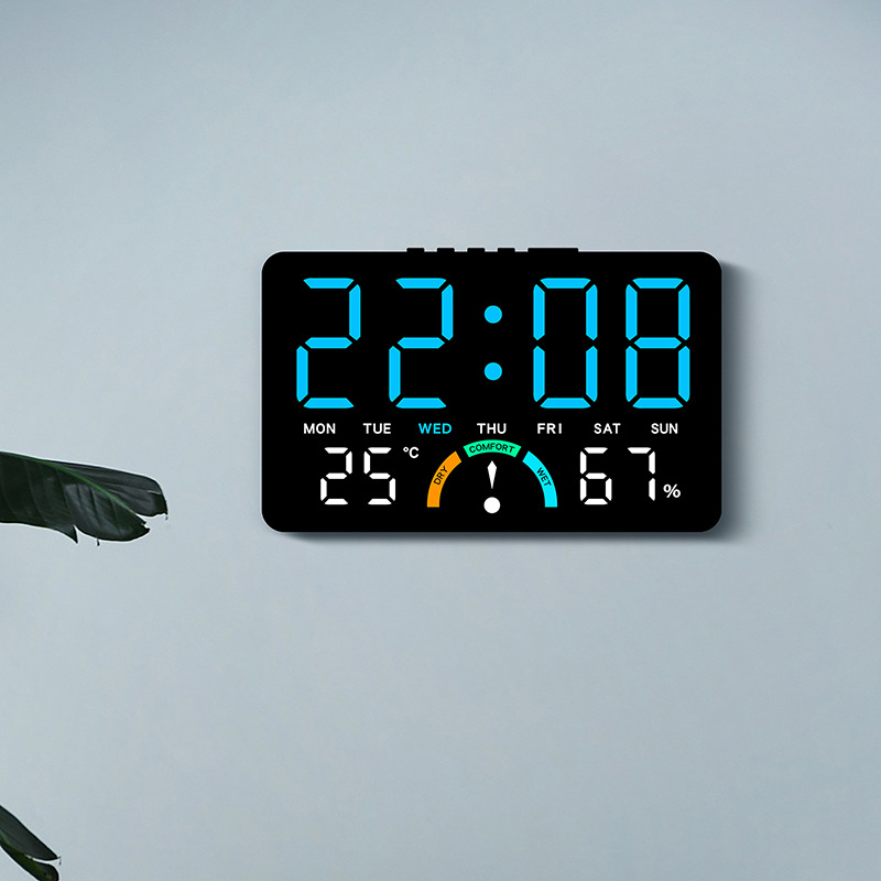this multifunctional led clock with a large display   hung or   on a table it shows time   temperature humidity and has two alarm settings       electricity and batteries