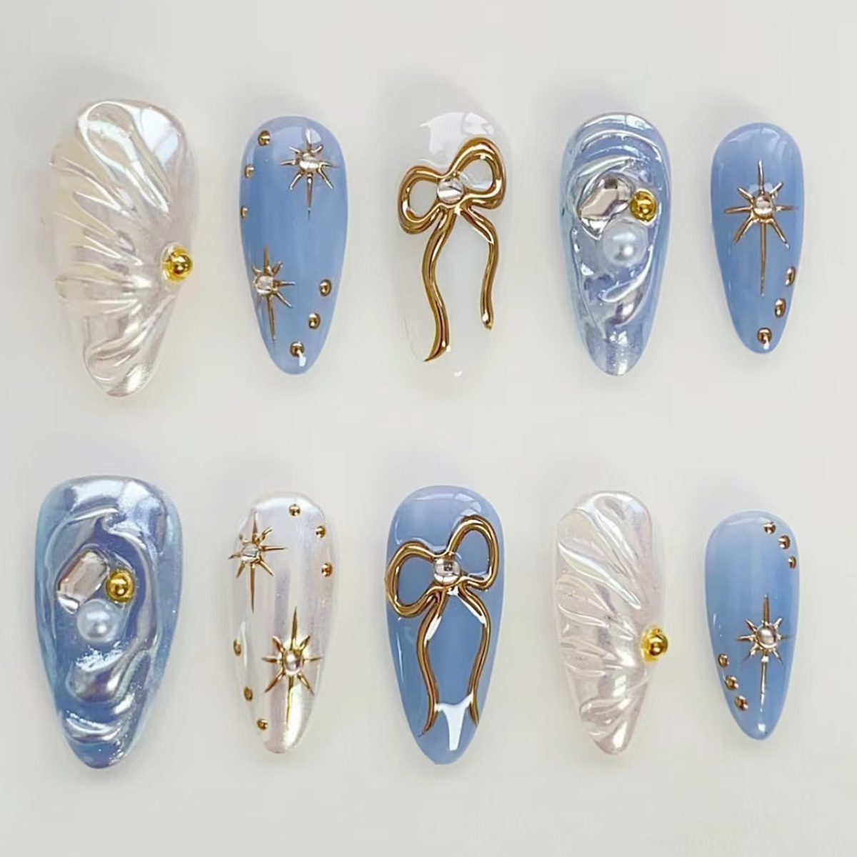 TEMU Your Style With 24pcs Of Luxury Almond-shaped Nails That Fit Perfectly To Your Nail Shape. Featuring -dimensional Ocean Blue With Golden Glitter, Bow, Starburst, And Wave Patterns