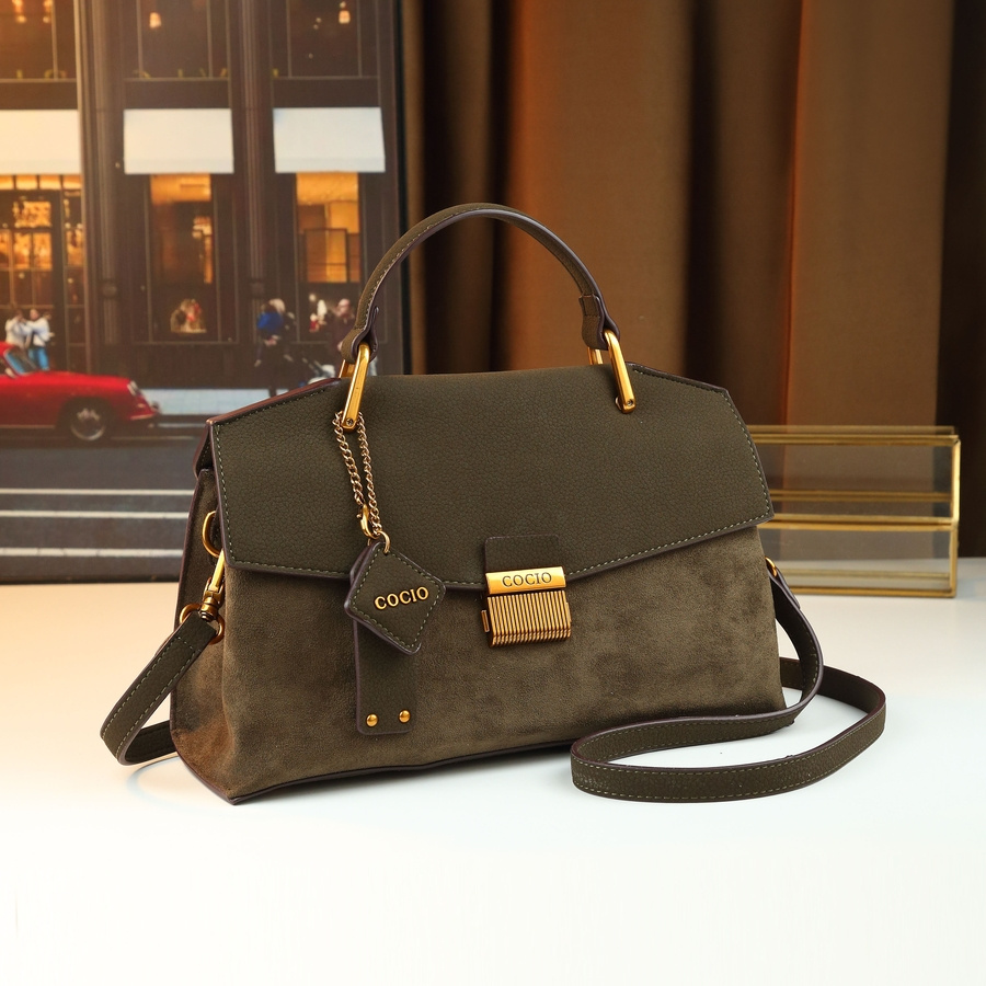 Handbag held by hand close up