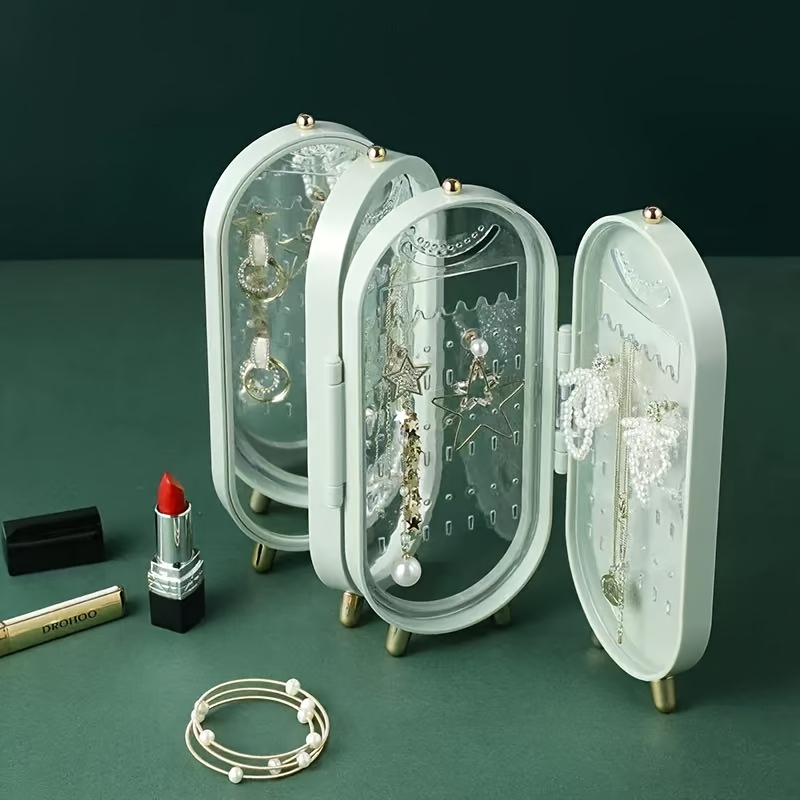 a foldable jewelry storage box with a   featuring a large capacity earring and necklace holder with   designed as an attractive display case for dressing tables it   a foldable earring clip jewelry organizer Product details 2