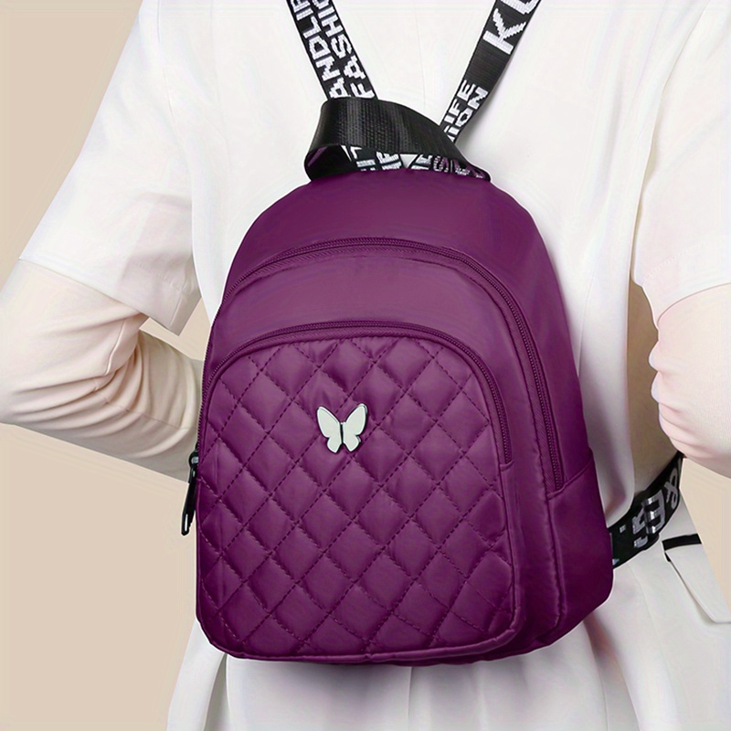 Mochila acolchada unisex, bolso de hombro para viaje y casual, con correas ajustables, múltiples compartimentos y logo de mariposa, disponible en 4 colores (negro, rojo, morado, azul), mochila para viajar con cierre de cremallera seguro