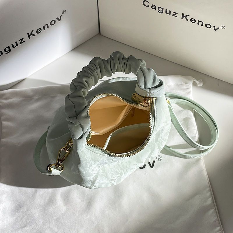 A Single Unit of The Latest Cloud Bag - a Small Pleated Clutch with an Adjustable Shoulder Strap, Featuring a Premium Matte End, Perfect for Everyday Use And Casual Events. This Compact Handbag Exudes Sophistication