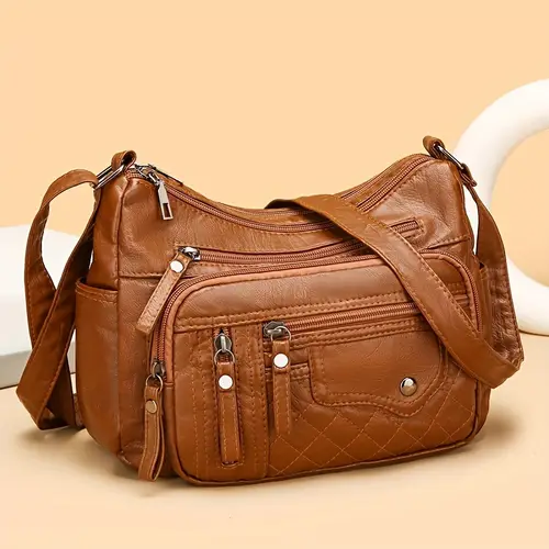 large capacity nylon shoulder bag with adjustable shoulder strap and anti theft zipper closure in light brown light gray red and black