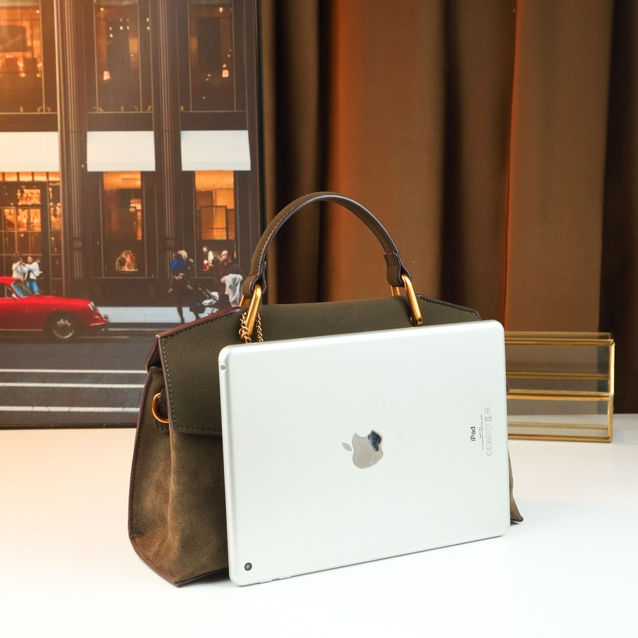 Golden-tone hardware and zipper detail