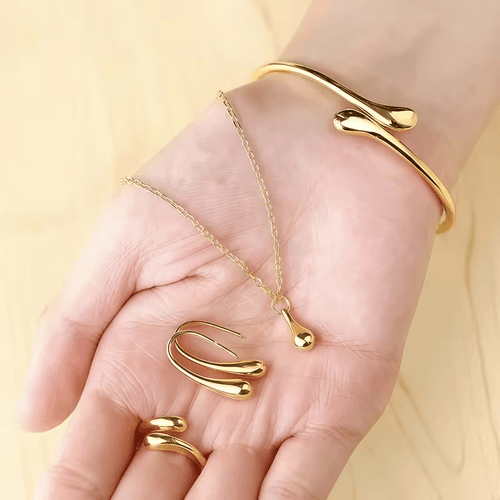 5pcs set womens simple and elegant golden jewelry set including a teardrop shaped necklace earrings bracelet and ring made of polished metal an elegant set suitable for daily wear and gifting does not a watch or box
