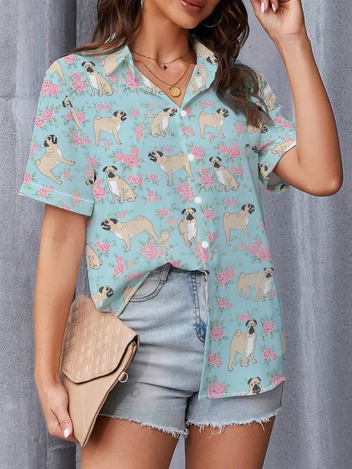 a stylish womens short sleeve shirt in light blue featuring a pattern of pugs and made of and machine washable this up top is a must have