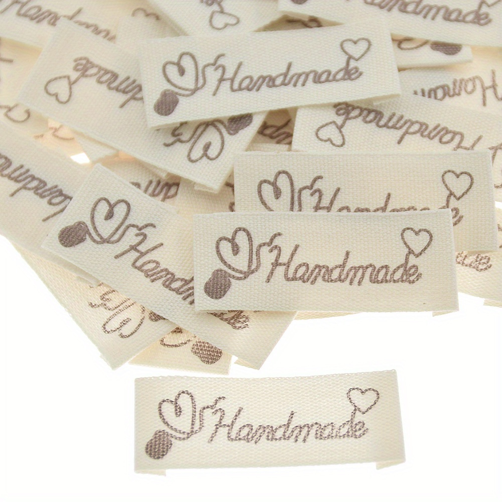 50pcs Off-white Heart Pattern Fabric Labels For Coats, Hats, Socks, Bags Fashion Tags