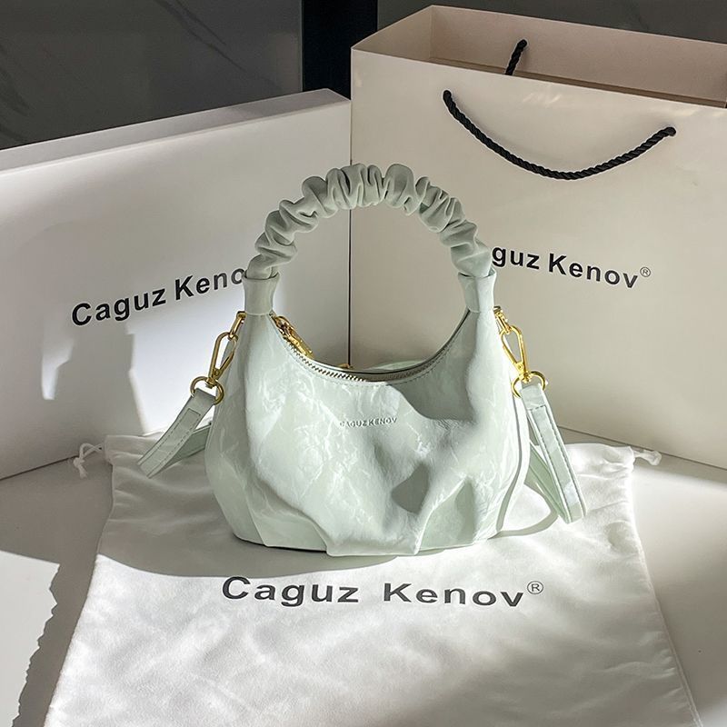 A Single Unit of The Latest Cloud Bag - a Small Pleated Clutch with an Adjustable Shoulder Strap, Featuring a Premium Matte End, Perfect for Everyday Use And Casual Events. This Compact Handbag Exudes Sophistication