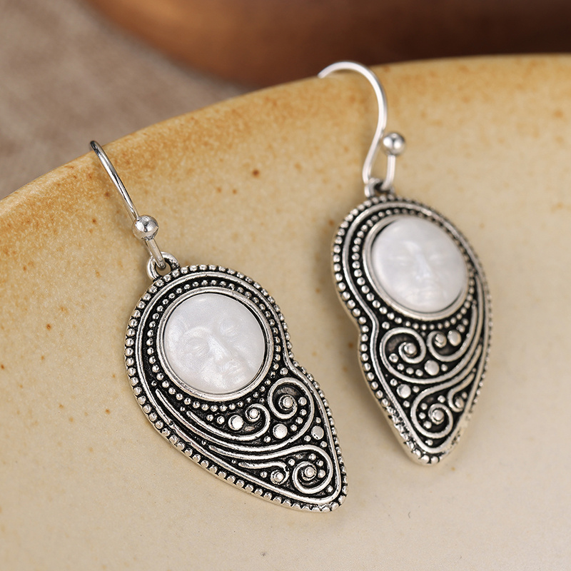 Vintage-style Silvery Teardrop Earrings with Embossed Design
