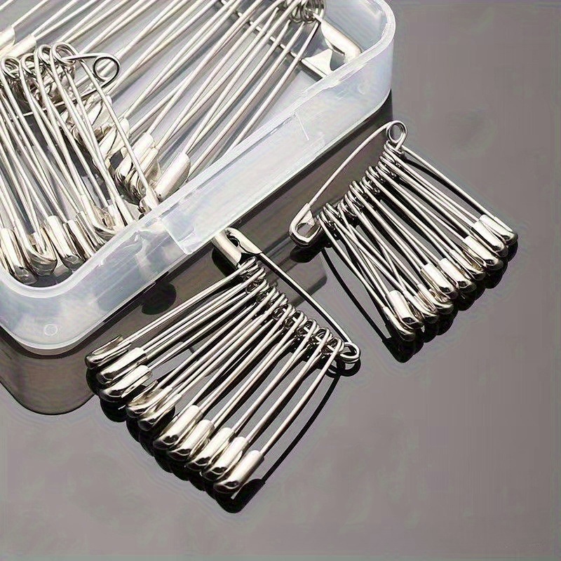a pack of 50 assorted sizes of safety pins galvanized metal silvery suitable for clothing tags and crafts