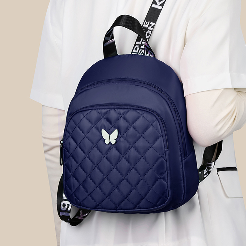 Mochila acolchada unisex, bolso de hombro para viaje y casual, con correas ajustables, múltiples compartimentos y logo de mariposa, disponible en 4 colores (negro, rojo, morado, azul), mochila para viajar con cierre de cremallera seguro