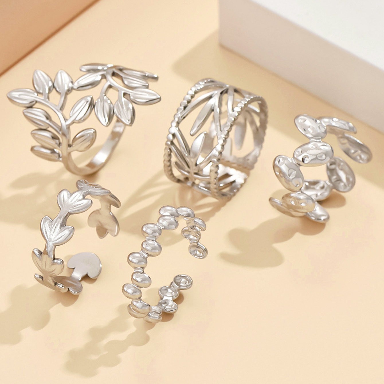 Image of A Set Of 5 Nature-inspired Open Rings For Women Featuring Floral, Leaf, And Branch Designs With Intricate Cutouts. Made Of Stainless Steel With An Plating Hypoallergenic. In Golden And Silver Colors