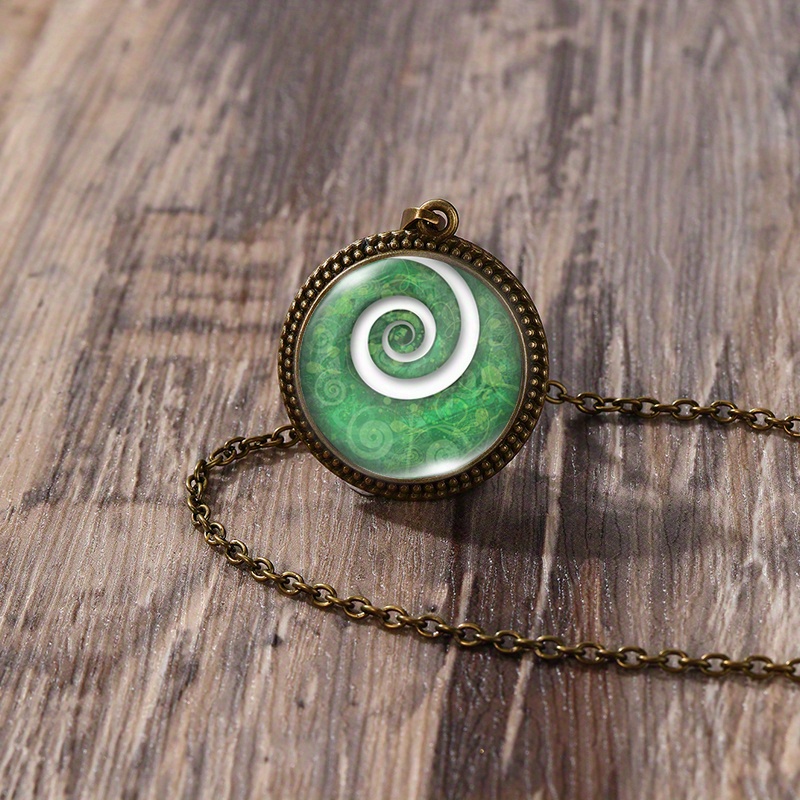 A Handmade Glass Pendant Featuring A 25mm Round Lace Design Of A Silvery Fern Koru Bud
