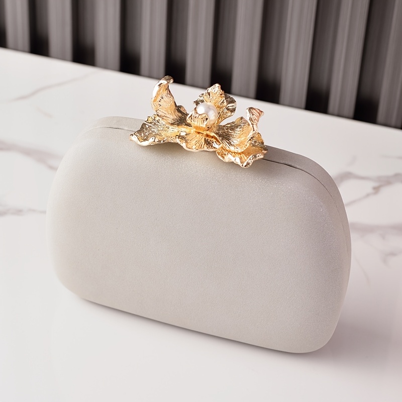 Versatile Solid Color Evening Bag Featuring A Metal Floral