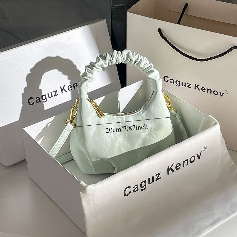 A Single Unit of The Latest Cloud Bag - a Small Pleated Clutch with an Adjustable Shoulder Strap, Featuring a Premium Matte End, Perfect for Everyday Use And Casual Events. This Compact Handbag Exudes Sophistication