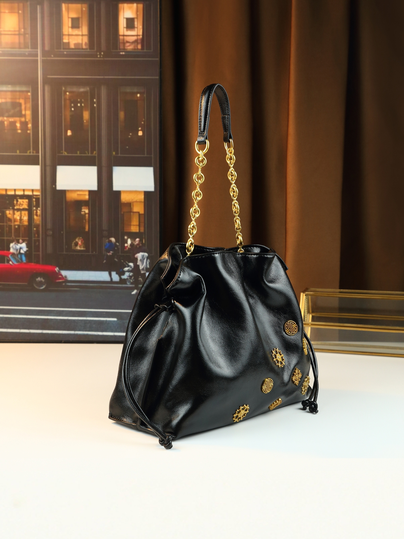 Black Drawstring Handbag close up of golden-tone hardware
