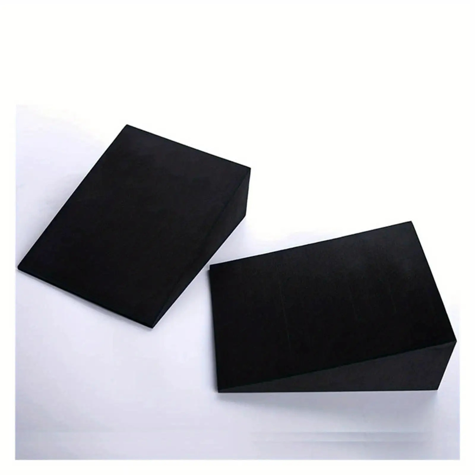 Two black squat wedge blocks on a white background