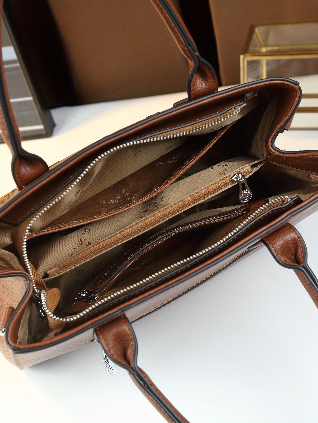 Light Brown Floral Print Handbag on flat surface