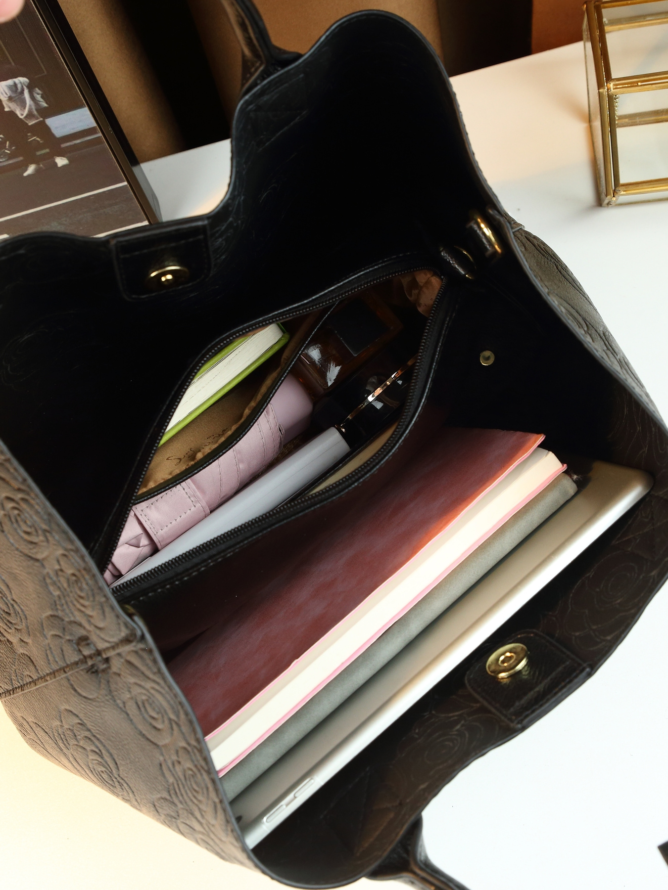 Model carrying tote bag in urban setting