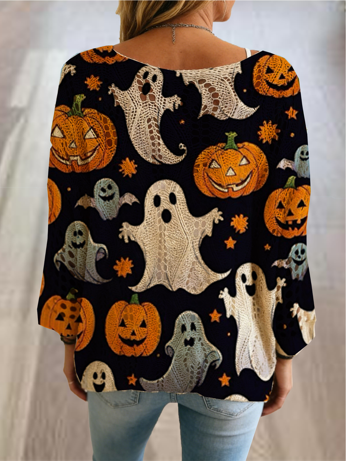 halloween style womens sweater round neckline diamond shaped cutouts bat shaped sleeves top with skull and pumpkin prints loose fit shoulder sliding design that   to   the figure suitable for use as an outer layer over bikinis