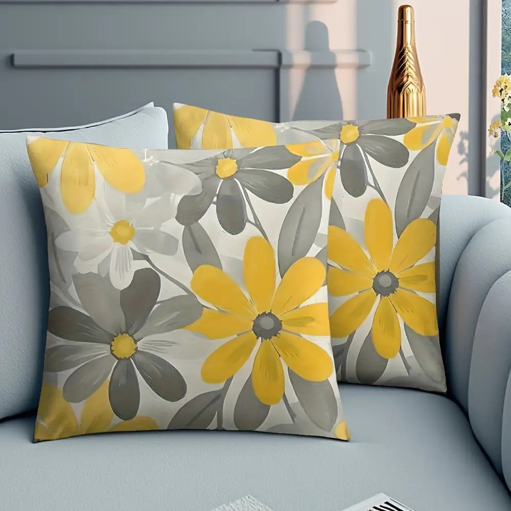 set of 2 single sided decorative pillows featuring a modern sunflower and daisy design in vibrant yellow and gray   square pillows are machine washable have a zipper closure and are perfect for decorating your sofa patio porch