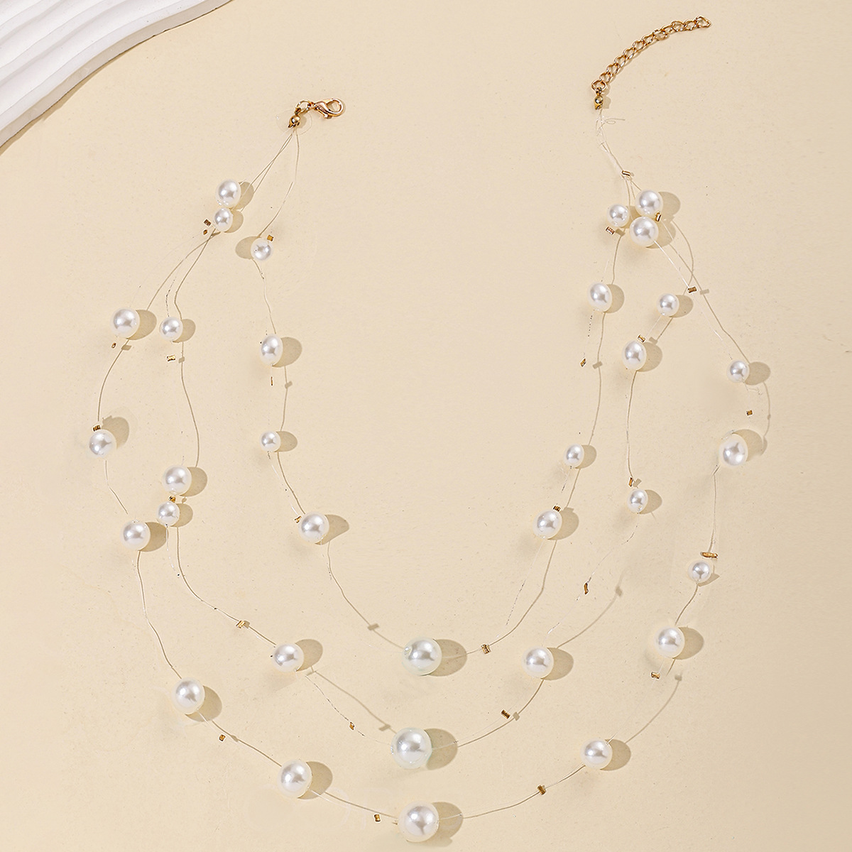 A Stylish And Versatile Layered Necklace With Tassels And Pearls, Featuring A Transparent Fishing