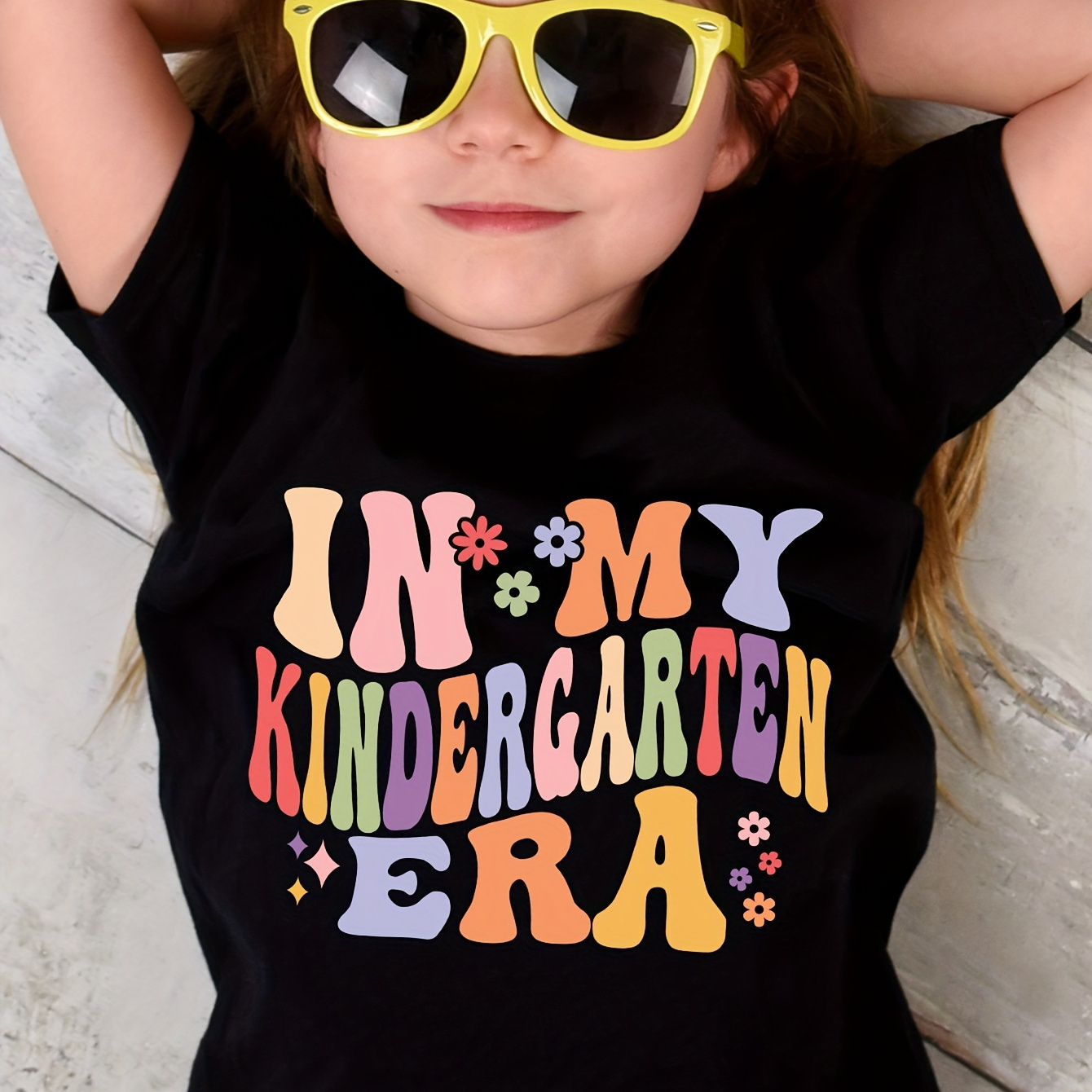 

In My Kindergarten Era & Cartoon Flowers Graphic Print, Girls' Casual & Comfy Crew Neck Short Sleeve T-shirt For Spring & Summer, Girls' Tee & Clothes For Outdoor Activities