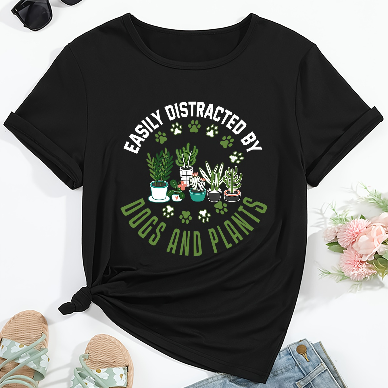 

Women's Casual Graphic T-shirt - "easily Distracted By Dogs And Plants" - Short Sleeve, Round Neck, Cartoon Plants And Paw Prints