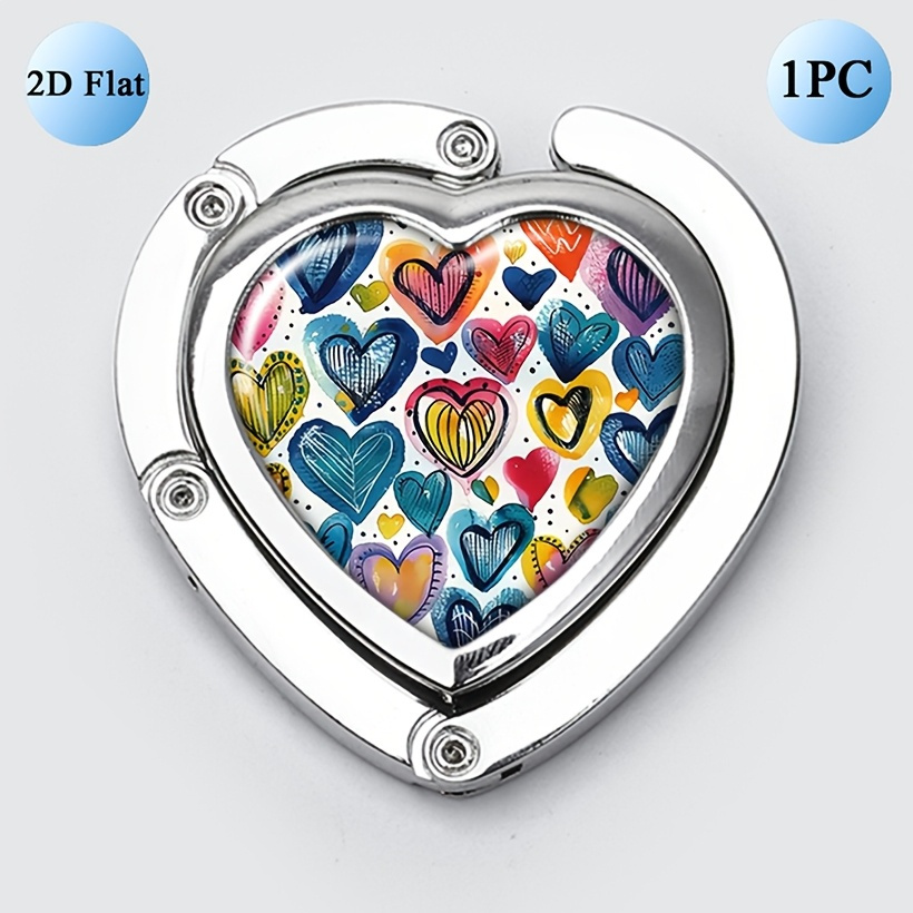 Adorable And Vibrant Purse Hanger Designed For Tables, Featuring A Heart Shape That Folds, Perfect For Holding Handbags, And Made Of Portable Metal