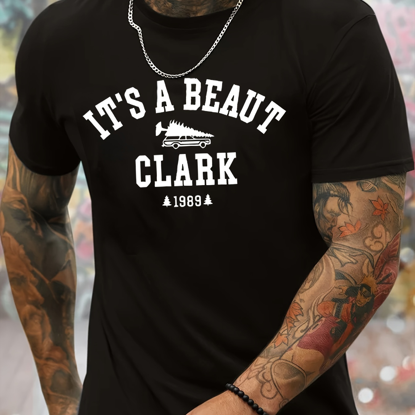 

It's A Beaut Clark And Car Carrying Christmas Tree Graphic Print, Men's Novel Graphic Design T-shirt, Casual Comfy Tees For Summer, Men's Clothing Tops For Daily Activities