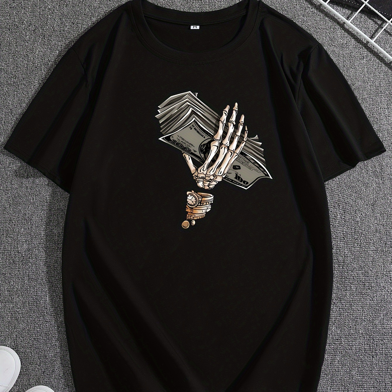 

T-shirt original design with cartoon skeleton hand holding money, perfect for casual and comfortable summer wear, ideal for daily activities.