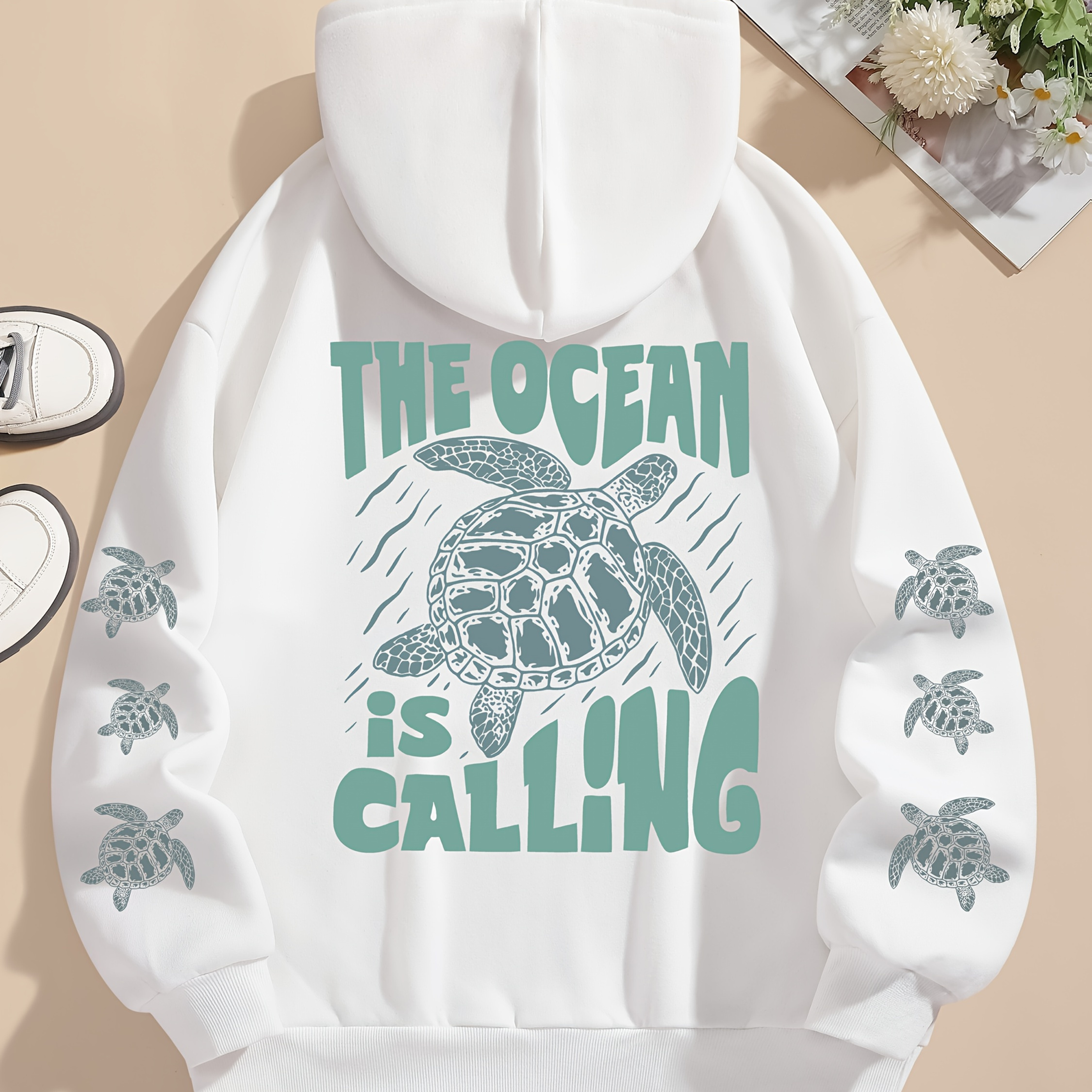 Women's Casual Loose Fit Hooded Sweatshirt with Kangaroo Pocket & Drawstring - White Ocean-Themed Graphic Print Featuring Sea Turtles & "The Ocean is Calling" Design, Machine Washable All-Season Comfort, Sea Turtle Decor, Comfortable Clothing, Durable Casualwear, Streetwear Fashion, Relaxed Style, Quality Stitching, Printed Hoodie, Ecoconscious Shoppers