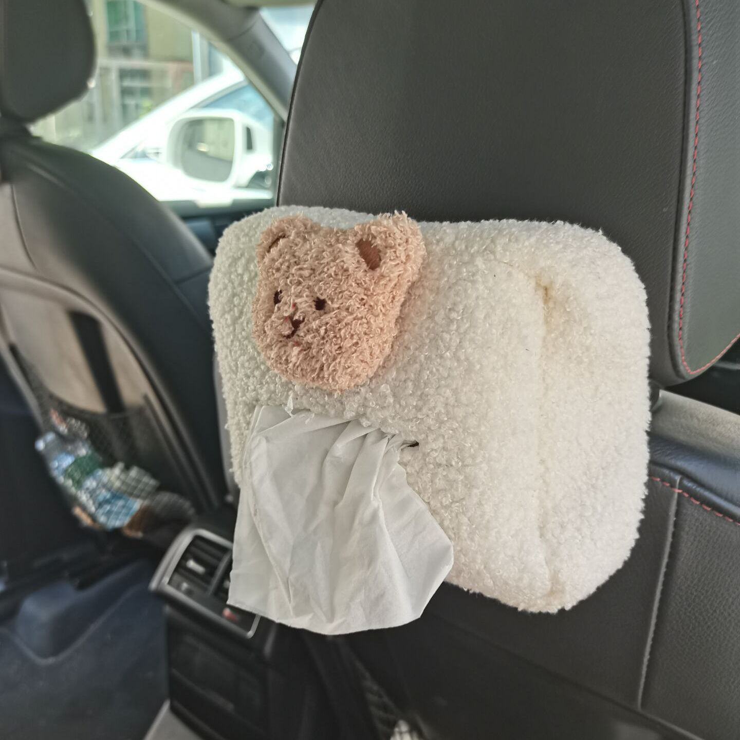teddy bear hanging from car