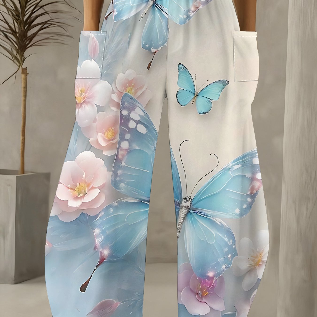 TEMU 【商品名】ハイウエスト ワイドレッグパンツ。ライトブルーの蝶とピンクと白の花柄プリントが特徴で、効果的なデザインとなっています。カジュアルなロングパンツで、オール対応。両サイドに大きなポケット付き。