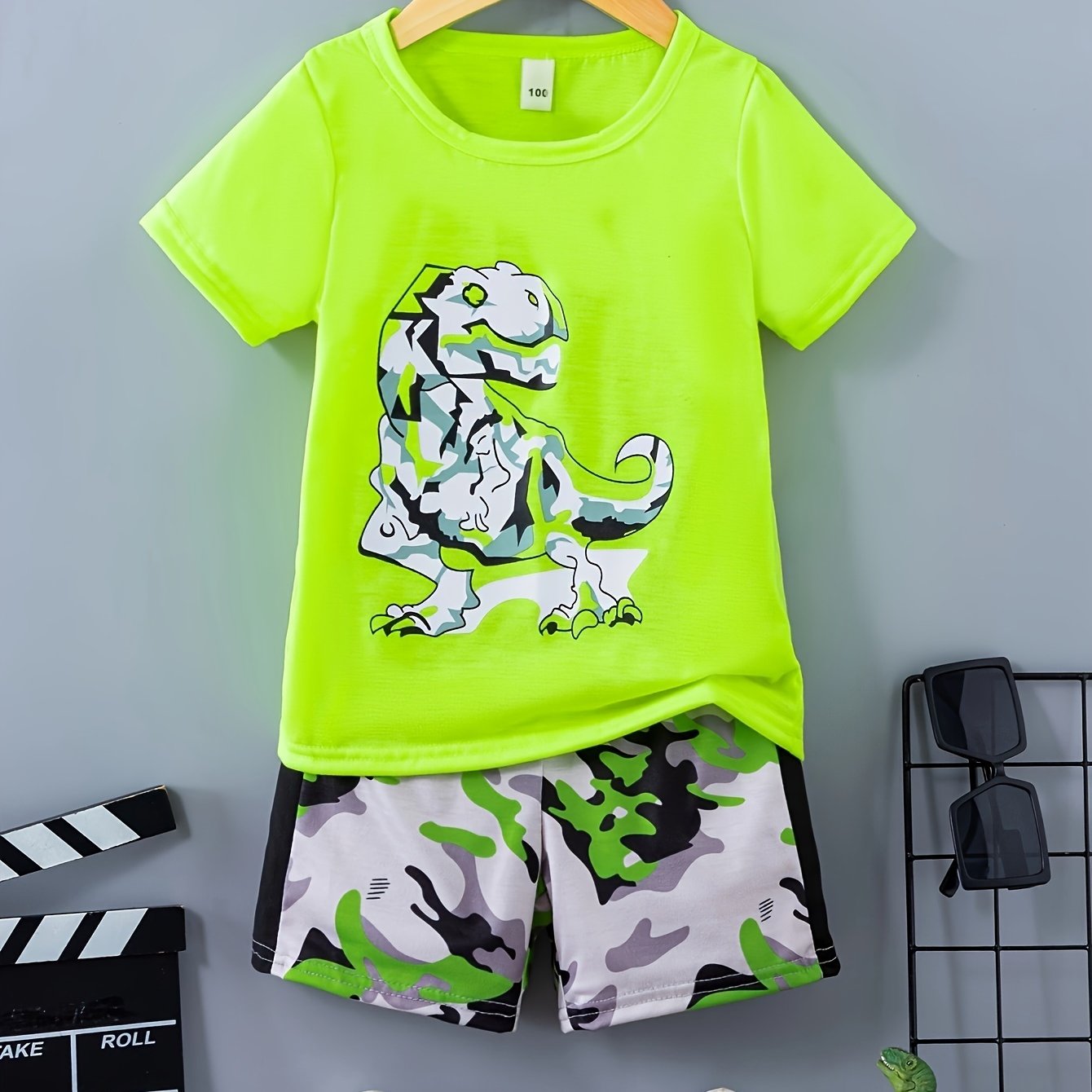A Two-piece Set For Boys Featuring Top With A Dinosaur Design And Camouflage Patterned Pants, For Outdoor