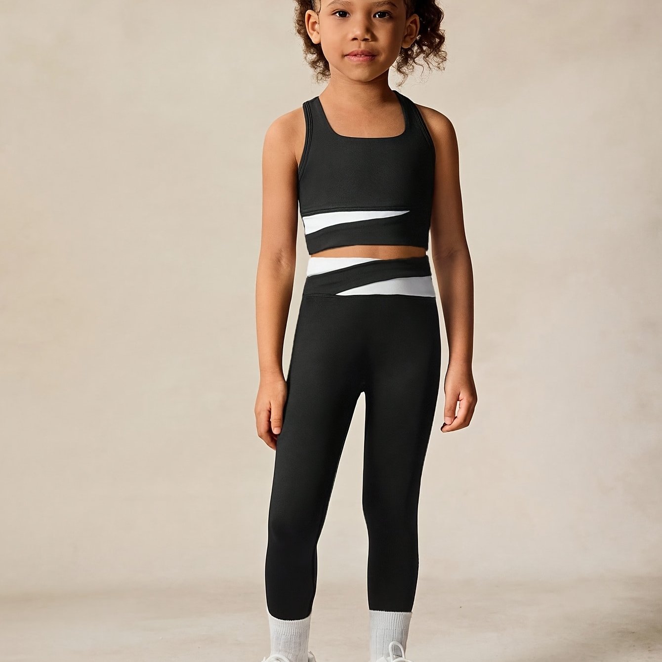 Image of A Stylish Black And - Sports Outfit For Girls, Featuring Tank Top With Long Pants, Designed With White Accents For A Easy Yet Fashionable Look. Perfect For Fitness And Everyday Activities, For Outdoor