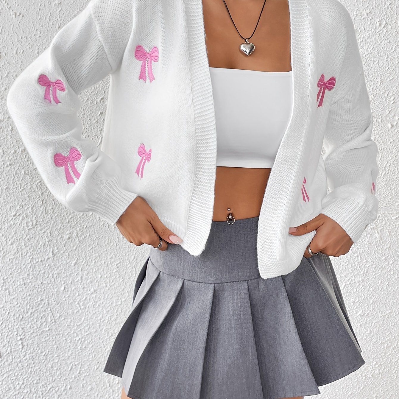 Image of A Simple Everyday Cardigan With A Bow Embroidery Pattern, Featuring A Loose Fit, Long Sleeves, And An Open Front Without Buttons. This Sweet, Fresh, And Top Exudes A Soft