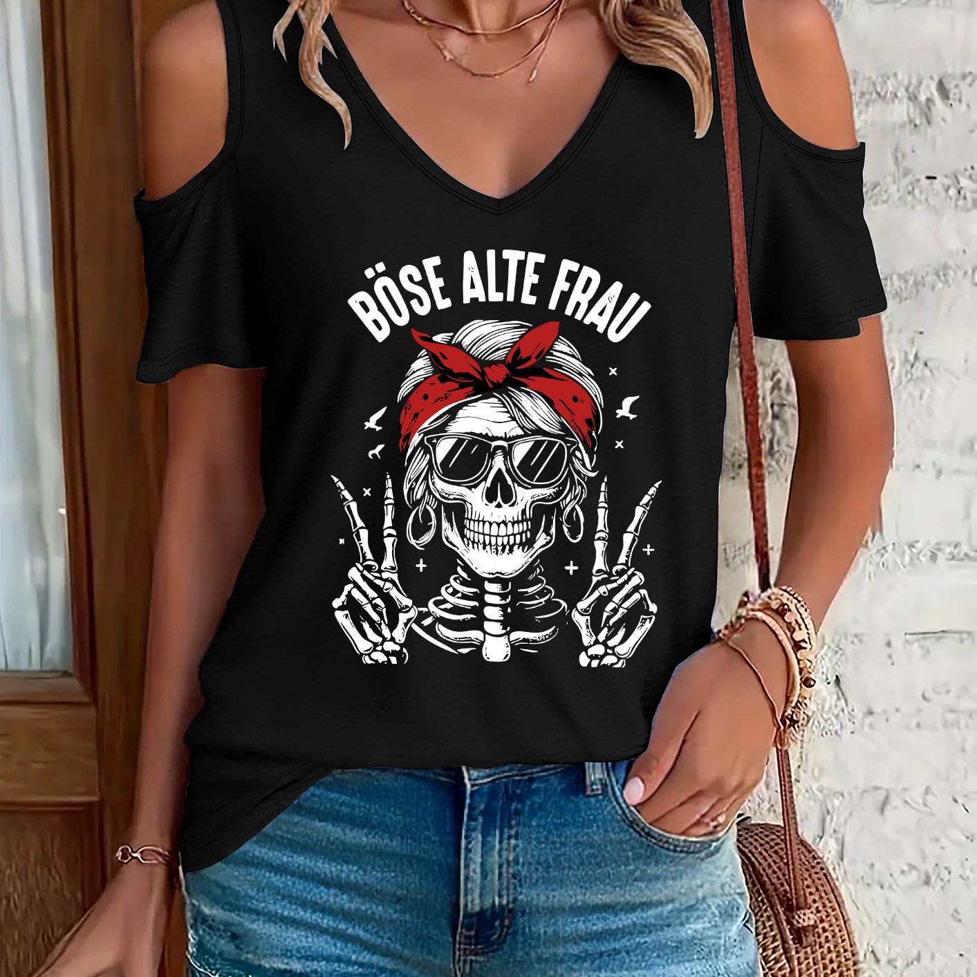 Image of Women's Casual Off-shoulder V-neck T-shirt With Skull Graphic & "böse Alte Frau" Print, Short Sleeve, Hem, White, Casual Attire | Skull Graphic Tee | Hem Top