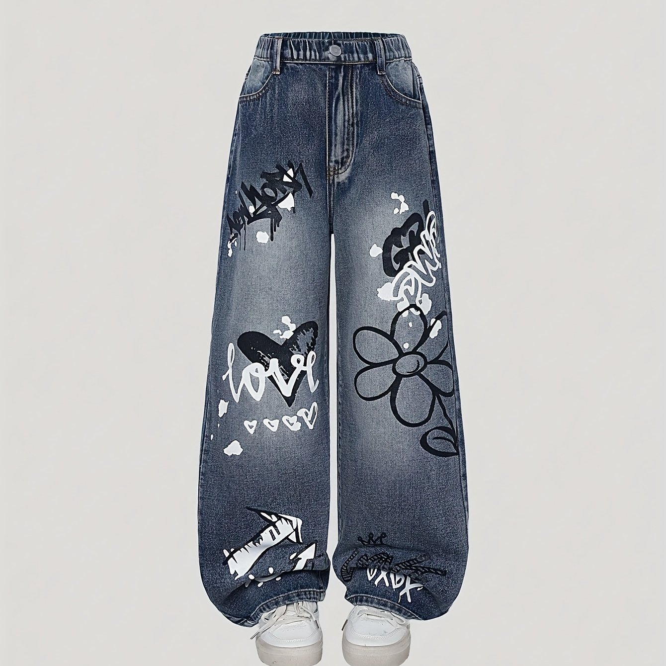 Girls' Trendy Cool Jeans, Featuring Y2k-style Graffiti Prints With A Of And Energy. Made From Vintage Washed Blue Denim With Loose Wide Leg Cuts For Yet Structure; The Legs Are Fully Covered In