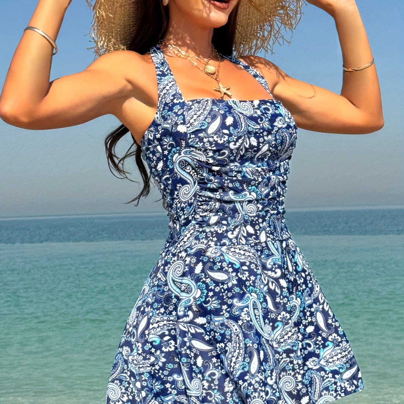 -piece Ethnic-style Top With , Adjustable Straps, Side , And A Flowing, Layered Skirt With Cascading Ruffles. It Features Triangle-shaped Pants In A Neutral Color.