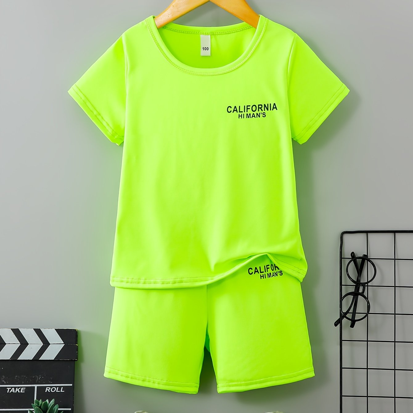 Image of A Two-piece Summer Outfit For Featuring A Fluorescent Green Short-sleeve T-shirt With 'california' And Matching Elastic Waist Shorts, Perfect For Comfortable Casual Wear In The Summer, For Outdoor